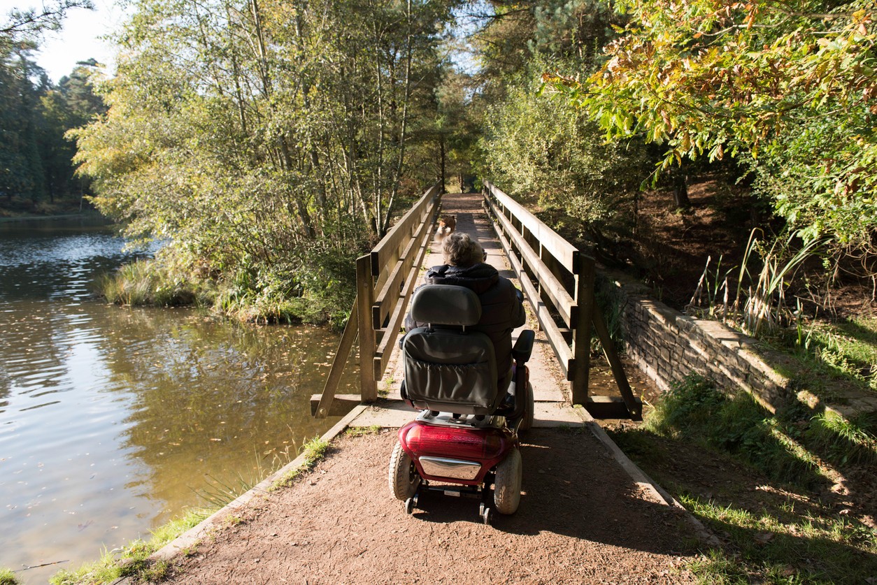 woman-and-mobility-scooter-on-trail