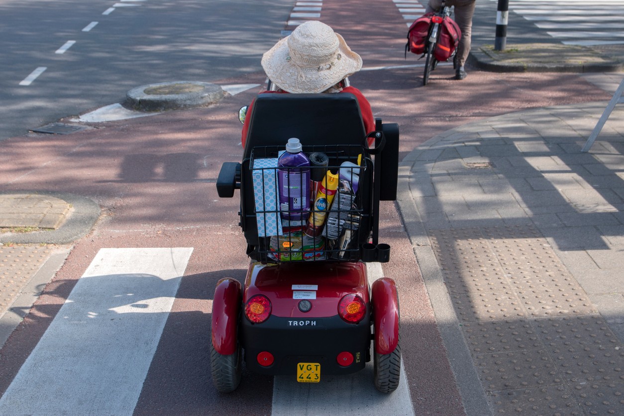 woman-crossing-street-on-mobility-scooter